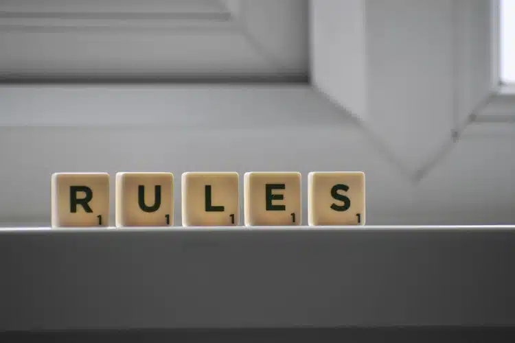 Scrabble squares positioned on a windowsill that read ‘RULES’.
